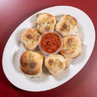 Garlic Knots · Fluffy rolls loaded with tasty garlic. Served with a 4 oz. large side of our marinara sauce.