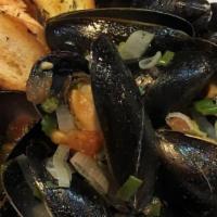 Steamed Mussels · Pei mussels cooked in white wine broth.