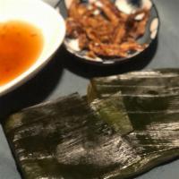Vietnamese Rice Tamale With Shrimp · Shrimp tamale wrapped in banana leaf with pork ear crackling, birds eye chili, charred scall...