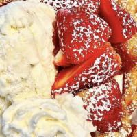 Funnel Cake · Fluffy funnel cake topped with powdered sugar, ice cream, whip cream and strawberries.