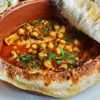 Moroccan Fish · Filet of Branzino in Spicy Tomato Sauce, Chickpeas, Cilantro, Tahini. Baked in Bread Dome