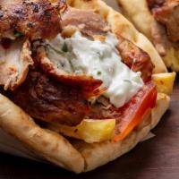 Pork Gyro - Sandwich · Layered pork gyro meat, cooked with fresh herbs & spices. Served in pita bread with lettuce,...