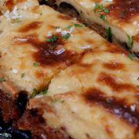 Mousaka · LAYERS OF EGGPLANT, GROUND BEEF & POTATOES, TOPPED WITH BECHAMEL SAUCE. SERVED WITH CHOICE O...
