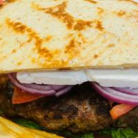 Greek Burger · Bifteki patty served in toasted pita bread with feta cheese, lettuce, tomatoes and onions, a...