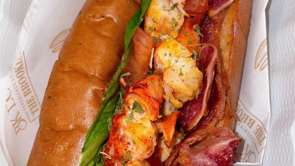Lobster Blt · Seasoned Maine lobster served with thick cut applewood bacon, fresh lettuce and crisp tomatoes. Served with your choice of seasoned fries or side salad.