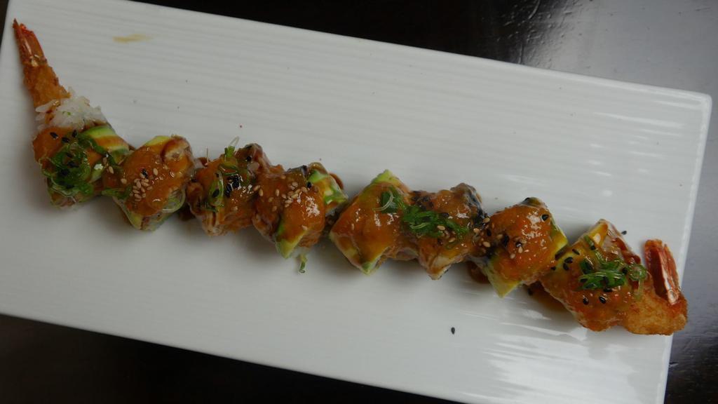 Dinosaur Roll · Shrimp tempura, avocado inside with eel, ginger sauce.