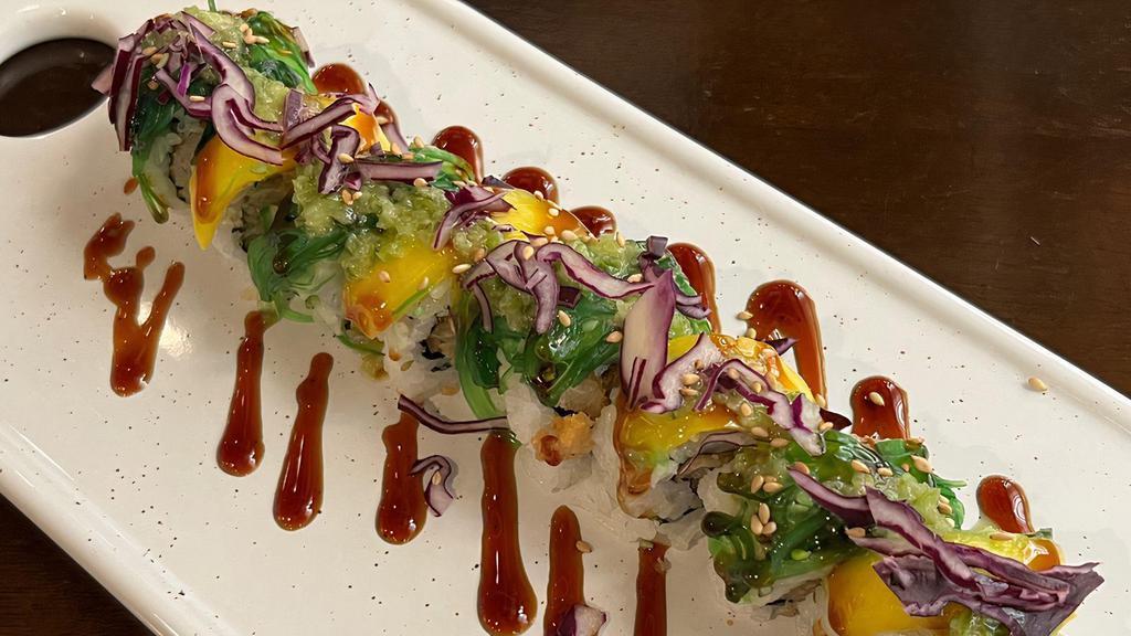 Mardi Gras Roll · Fish tempura inside, topped with seaweed salad, mango, and a sprinkling of purple cabbage. finished with eel sauce and jalapeno sauce.
