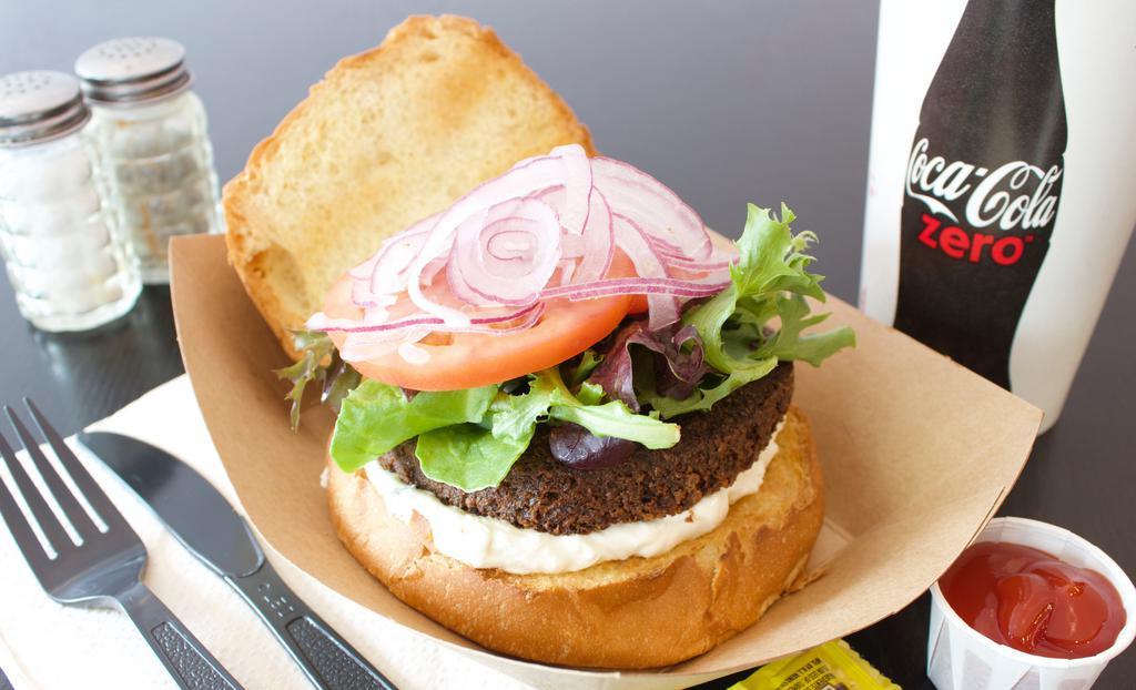 Falafel Burger · Served with lettuce, tomato, and onion as well as your choice of tahini or tzatziki sauce.