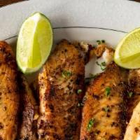 Tilapia · Semolina dusted fresh tilapia fillet pan fried seasoned with salt, pepper and lemon served w...