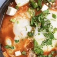 Shakshouka Breakfast (1) · 2 EGGS POACHED IN TOMATO SAUCE, TOPPED CILANTRO,JALAPEÑO AND QUESO FRESCO SERVED WITH PITA