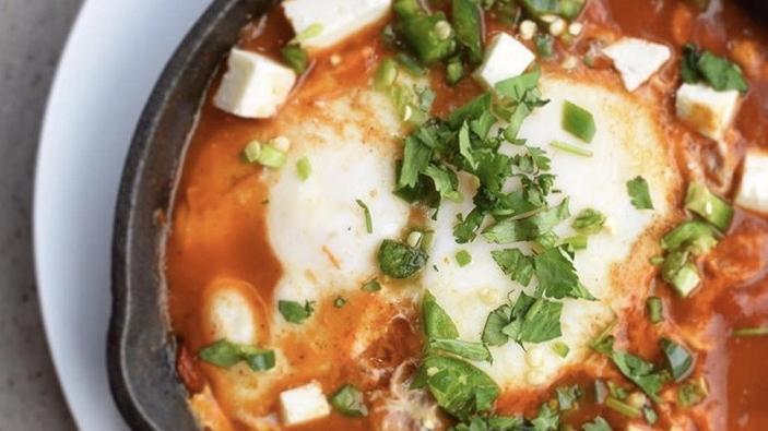 Shakshouka Breakfast (1) · 2 EGGS POACHED IN TOMATO SAUCE, TOPPED CILANTRO,JALAPEÑO AND QUESO FRESCO SERVED WITH PITA