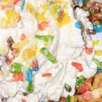 Fruity Pebble Treat Waffle · Waffle topped with marshmallow fluff, Fruity Pebble cereal, sweet milk, and whipped cream.