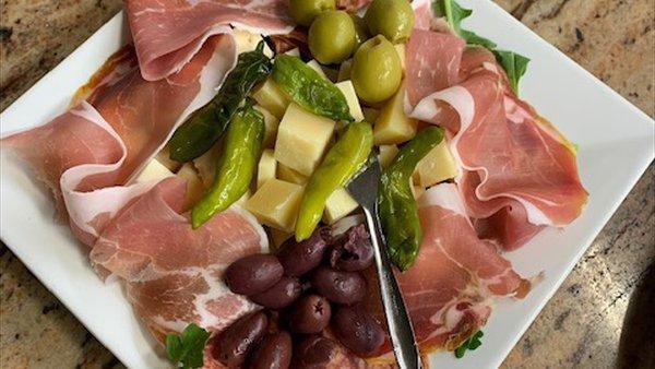 Salumi Board · prosciutto di parma, sopressata, aged provolone, parmigiano reggiano, shishito peppers and assorted olives