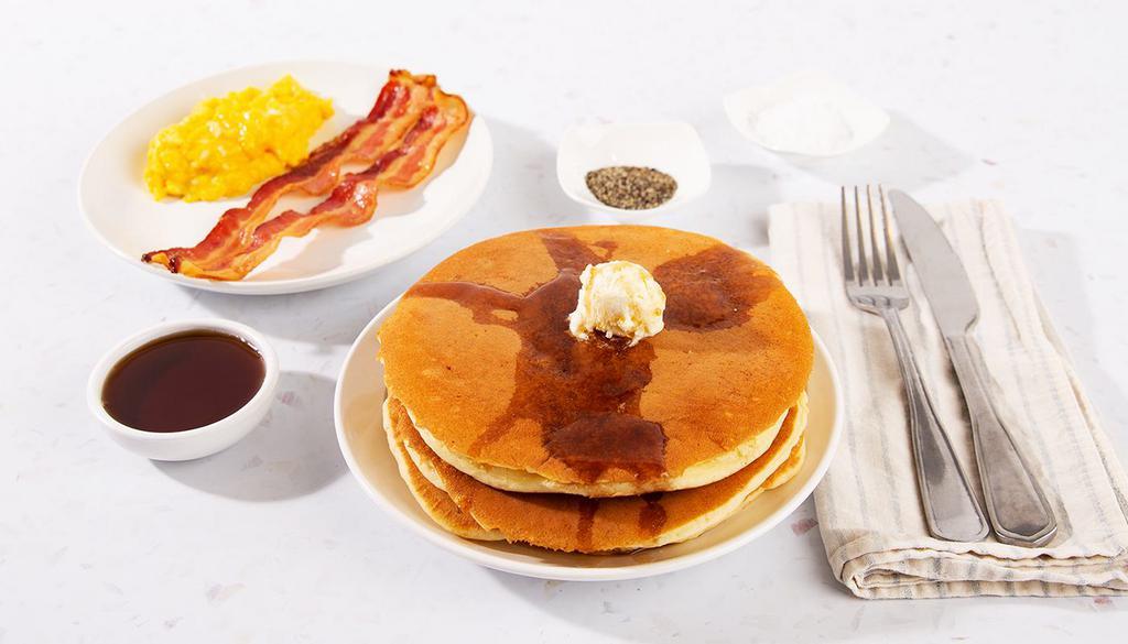 Pancake Combo · Two fluffy buttermilk pancakes served with maple syrup and powdered sugar, plus your choice of breakfast meat and two eggs your way.