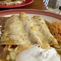Enchiladas Suizas · Soft corn tortillas dipped in green tomatillo sauce, filled with shredded chicken, and cover...