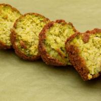 Falafel · 4 pieces. Crispy, deep fried fritters made from ground chickpeas, beans and a blend of aroma...