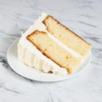 Pina Colada Cake Slice · A Super moist Pineapple Rum Cake with Vanilla Frosting and Coconut Shavings.
