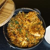 Chicken Biryani · Gluten free. Long grained basmati rice, fresh herbs and spices served with yogurt raita.