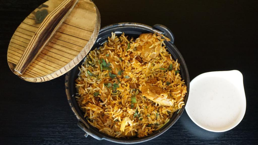 Chicken Biryani · Gluten free. Long grained basmati rice, fresh herbs and spices served with yogurt raita.