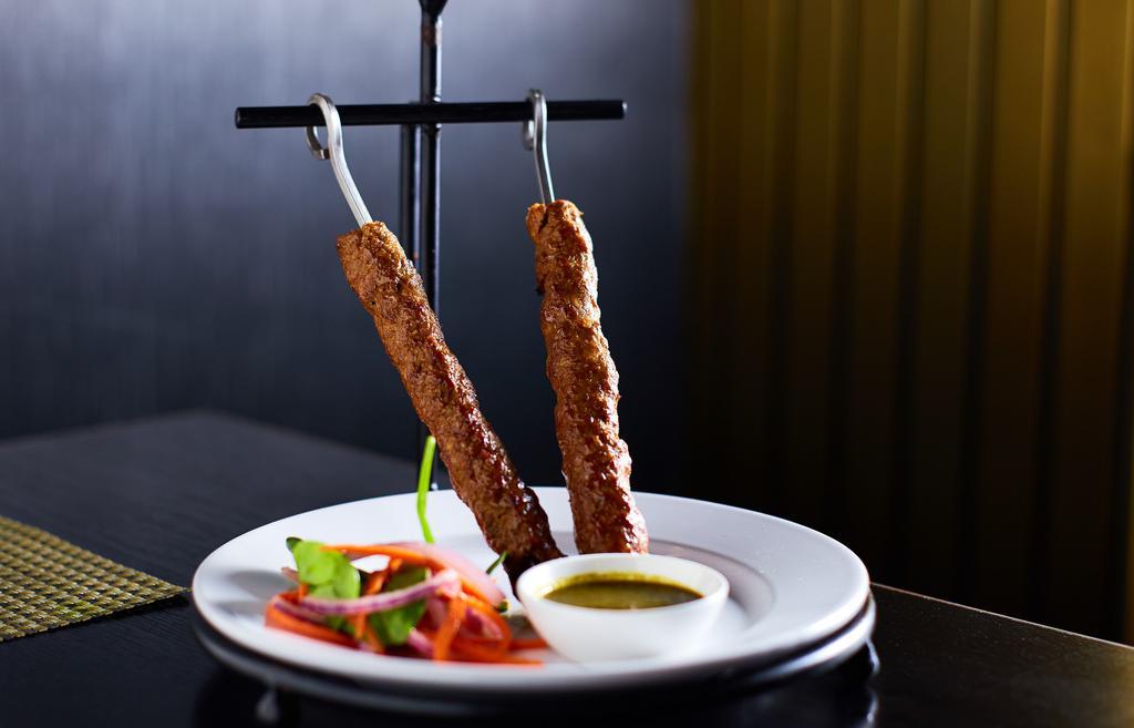 Lamb Seekh Kebab · Skewers of ground lamb mixed with a blend of spices, served with mint chutney.