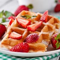 Strawberry Waffles · Lightly crisp waffles with strawberries, syrup and butter on top.