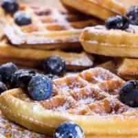 Blueberry Waffles · Lightly crisp waffles with blueberries, syrup and butter on top.