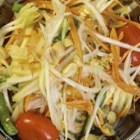 Papaya Salad · Central thai style green papaya salad with spicy chili lime dressing, grape tomato, green be...