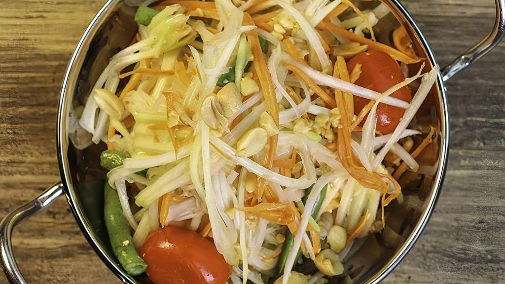 Papaya Salad · Central thai style green papaya salad with spicy chili lime dressing, grape tomato, green bean, and crushed roasted peanut. Mild.
