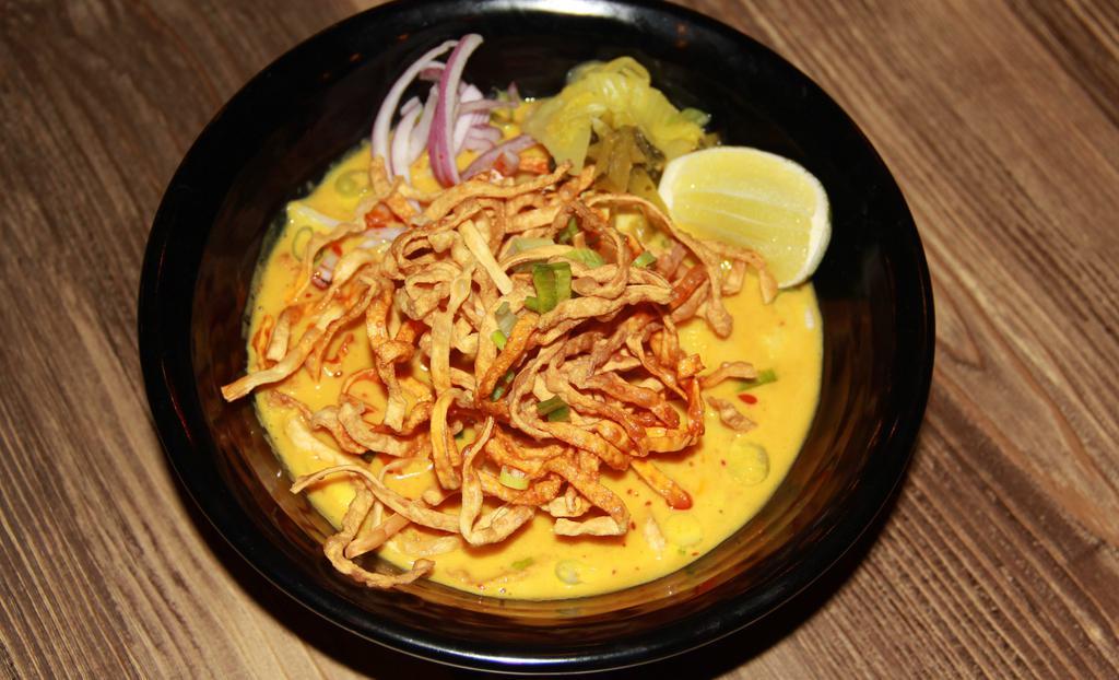 Khao Soi · Crispy egg noodle w/ mild yellow curry, scallions, red onions, bean sprouts and pickled mustard greens.