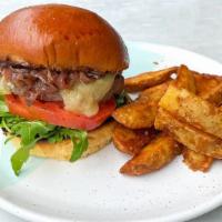 Impossible Bayside Burger · The Impossible™ burger, cheddar cheese, caramelized onions, fig jam, aioli, arugula &  tomat...