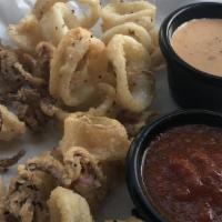 Calamari · Hand dredged, topped with cherry pepper aioli and served with marinara sauce.