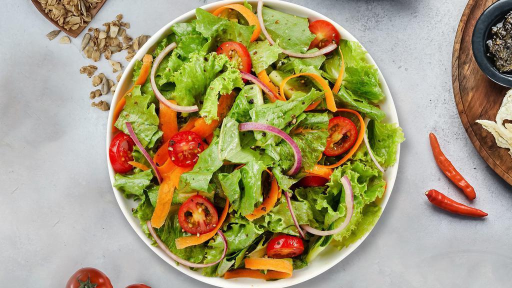 Mixed Greens Salad · (Vegetarian) Romaine lettuce, cherry tomatoes, carrots, and onions dressed tossed with lemon juice & olive oil.