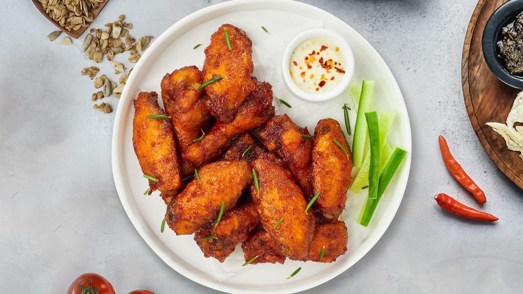 Buffalo Chicken Wings · Ten pieces of fresh chicken wings breaded, fried until golden brown, and tossed in buffalo sauce. Served with a side of celery, carrots, bleu cheese, and your choice of sauce.