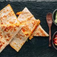 Spicy Cheese Quesadilla · Hot off the griddle, mouthwatering quesadilla made with a fine blend of cheeses, peppers, an...