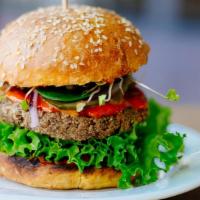 Veggie Burger · Fresh off the grill Veggie Burger topped with lettuce, tomato, and onion.