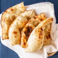 Naan · Unleavened tandoori baked bread made of flour and enriched with milk.