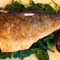 Whole Roasted Branzino · Served with sauteed spinach and grilled lemon.