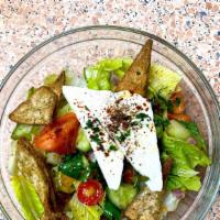 Greek Salad · Marinated Tomato, red onion, black olives, cucumbers, Romaine, feta