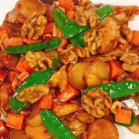 Chicken With Three Different Nuts · Sliced chicken sautéed with water chestnuts and snow peas in a brown sauce and garnished wit...