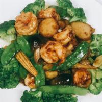 Roast Garlic Prawns · Prawns sautéed with roasted garlic, scallions, and black pepper, served over a bed of steame...
