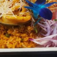 Arroz Con Mariscos (Peruvian Paella) · Seafood rice with calamari, shrimps, mussels, and clams, served with salsa criolla.