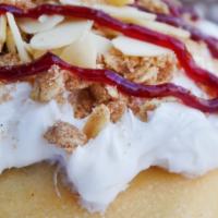 Creme Brulee Roll · Creme Brulee frosting topped with almonds, pie crumble and raspberry Jam.