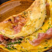 Wild West Omelette · Delicious Omelette cooked with 3 eggs and topped with Ham, Peppers, and Onion. Served with c...