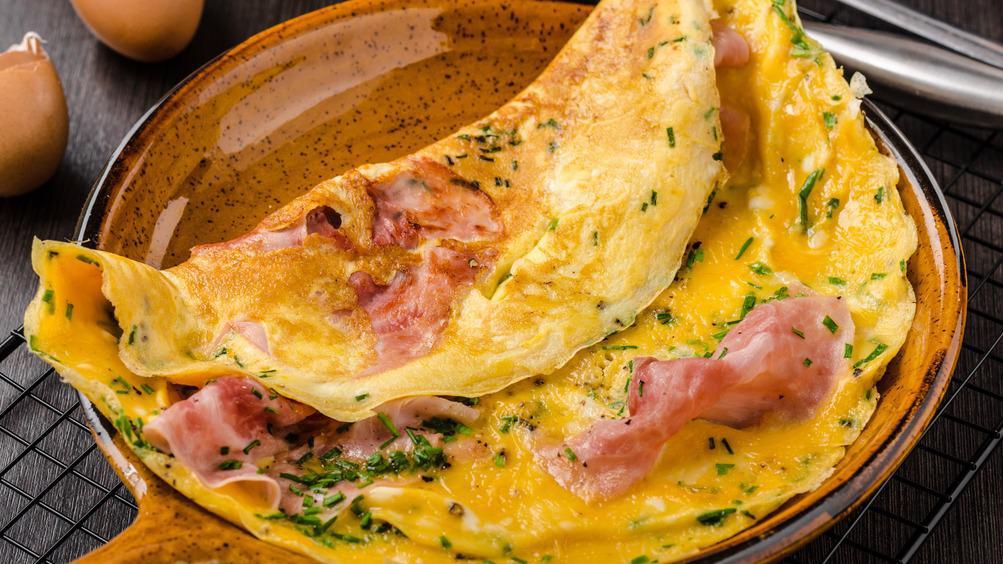 Wild West Omelette · Delicious Omelette cooked with 3 eggs and topped with Ham, Peppers, and Onion. Served with customer's choice of toast and potatoes.