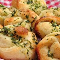 Garlic Knots 4 Pcs · Garlic Knots are Strips of Pizza Dough tied in a Knot, Baked, & then Topped with Melted Butt...