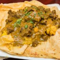 Curry Goat · Your choice of a dhalpuri or bussup roti with chickpeas & potatoes and 'Boneless' curry goat.