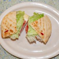 Turkey Club Sandwich · Sliced turkey, bacon, lettuce and tomato.