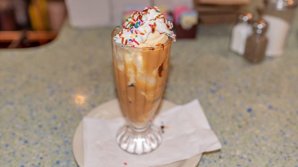 Peanut Butter Cup Sundae · Two scoops of vanilla ice cream covered with hot fudge and smooth peanut butter topping, topped with whipped cream, peanuts and cherry.