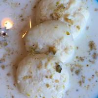 Rasmalai · Soft curdled milk whey balls, saffron & cardamom milk.