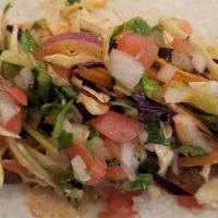 Fish Taco · Fried Fish, mixed cabbage, Chipotle mayo, and guacamole sauce on a flour tortilla.